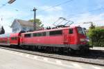111 066-7 am 1. Mai 2012 beim Halt im Bahnhof von Prien am Chiemsee.