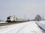1116 264  3 Hitradio  mit einem Korridorzug von Salzburg nach Innsbruck unterwegs. Aufgenommen am 24. Februar 2013  bei bersee am Chiemsee.